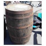 Wooden whiskey barrel with metal straps, bung
