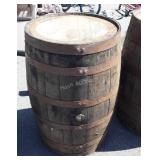 Wooden whiskey barrel with metal straps, with