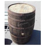 Wooden whiskey barrel with metal straps, bung