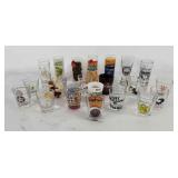Group of souvenir shot glasses, also includes