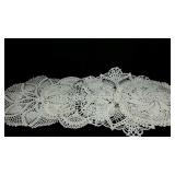 Group of doilies and a table runner, over 30