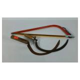 Bow saw and two hand scythes.