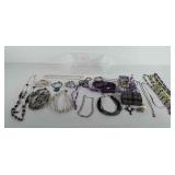 Small storage bin of costume jewelry, coin