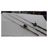 Group of three fishing rods, two with reels, one