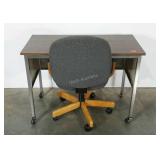 Desk and chair, both roll on casters, desk
