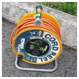 Electric extension cord with power outlet reel