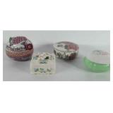 Four porcelain trinket boxes, one includes music
