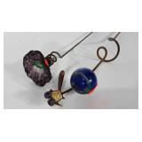 Art glass garden decorations on metal stakes.