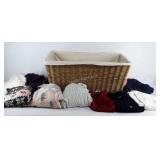 Group of knitted sweaters and large basket with
