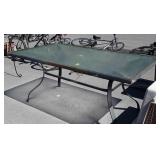 Glass top patio table,  62 x  36 inches