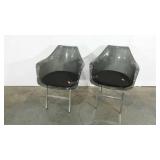 Pair of smoked acrylic chairs with padded seats,