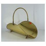 Footed brass fireplace log holder, 21" long