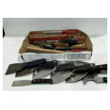 Flat of handtools. Lots of scrapers, some