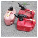 Three One gallon Gas cans, one full with mixed