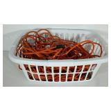 Orange extension cords in laundry basket, 4 cords