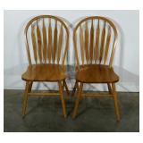 Two arrow back dining chairs in oak finish.
