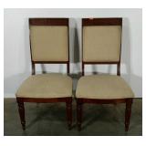 Two upholstered dining chairs with Greek design.
