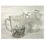 Two glass pitchers, black and white with