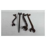 Tools, three curved open-ended wrenches and one