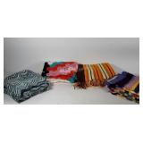 Four knitted blankets, two with fringed edges,
