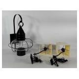 Three wall mounted light fixtures, one large