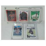 Five collectible sports cards, three with