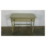 Simple desk with single drawer and turned legs.