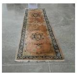 Older wool runner rug in muted tones. Needs