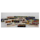 Group of model train cars and engines, most with