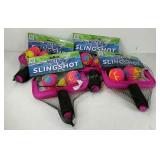 Four water slingshot pool toys, new in packaging.