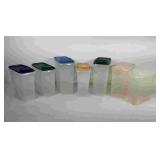 Seven Tupperware cereal storage containers, all