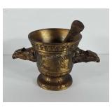 Brass pestle and mortar with eagle head handles,