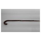 Wooden walking cane with metal tip, some