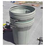 Two residents trash cans with lids