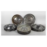 Group of hubcaps, includes one Dodge Lancer