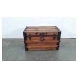 Large wooden flat-top trunk with leather handles,