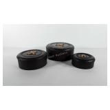 Three nesting button style tins