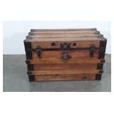 Large wooden flat-top trunk with leather handles,
