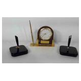 Three desk pen stands, one brass clock stand with
