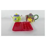 Two ceramic teapots and heart shaped ice cube