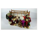 Dolls cradle with group of plush animals, some