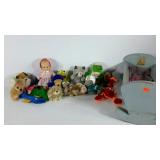 Dolls cradle with a group of plush animals