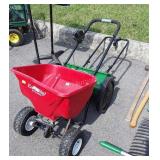 Two Fertilizer spreaders, red one well used