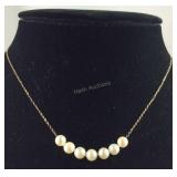 14k gold necklace with seven 5mm pearls 16in