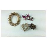 Four brooches one is missing a stone