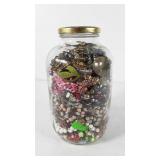 Glass jar full of jewelry, includes necklaces,