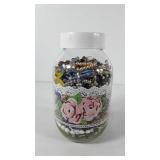Glass jar full of jewelry, includes necklaces,