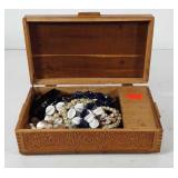 Wooden jewelry box with necklaces, bracelets, and