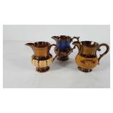 Three ceramic creamers