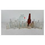 Seventeen glass bottles, includes Burnett